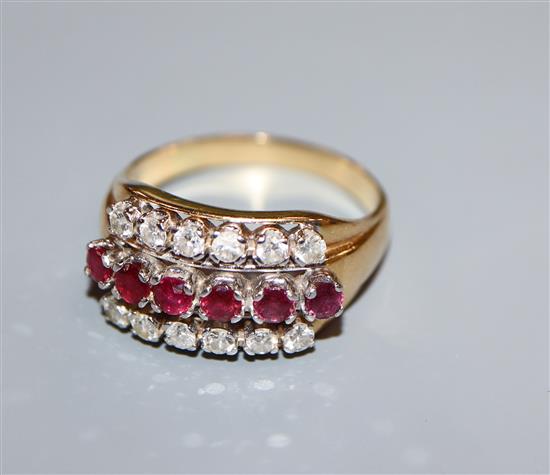 An 18k gold ruby and diamond triple row ring, size S